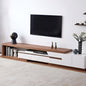 Modern living room with a wooden and white TV stand, television, and decorative items.