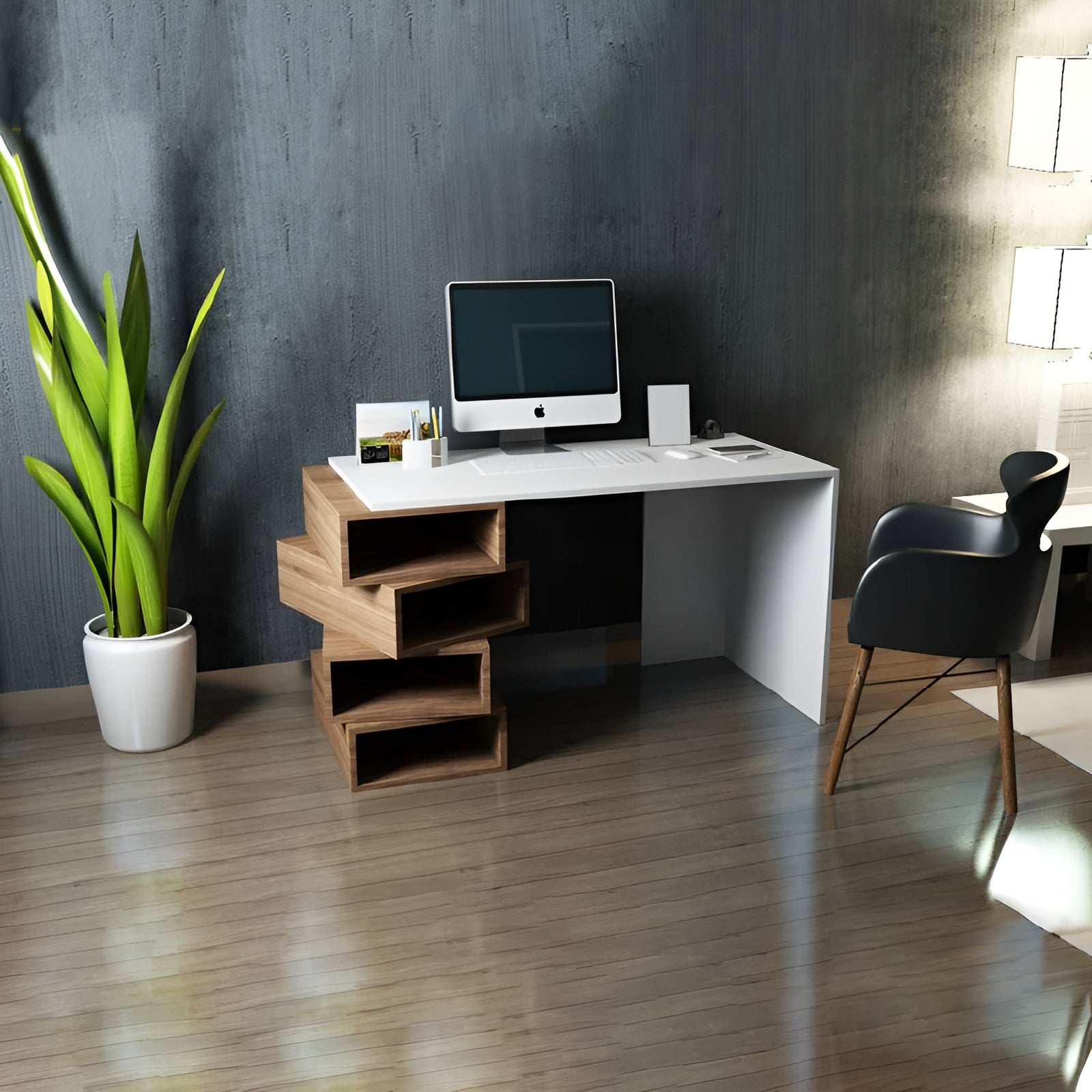 Modern office desk with computer setup in a room with a plant and chair.