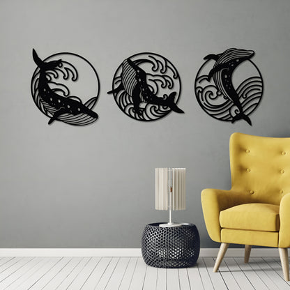 Three black dolphin wall decorations on a gray wall with a yellow chair and small table in the foreground.