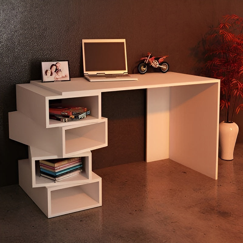 White corner desk with a laptop, books, and decorative items in a room with a dark wall and plant.
