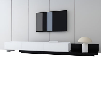 Modern black and white entertainment console with a television mounted on the wall.