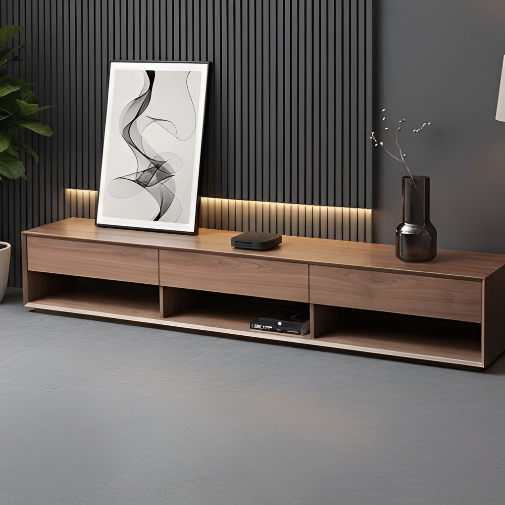 Wooden TV stand with a vase and framed abstract art against a dark wall.
