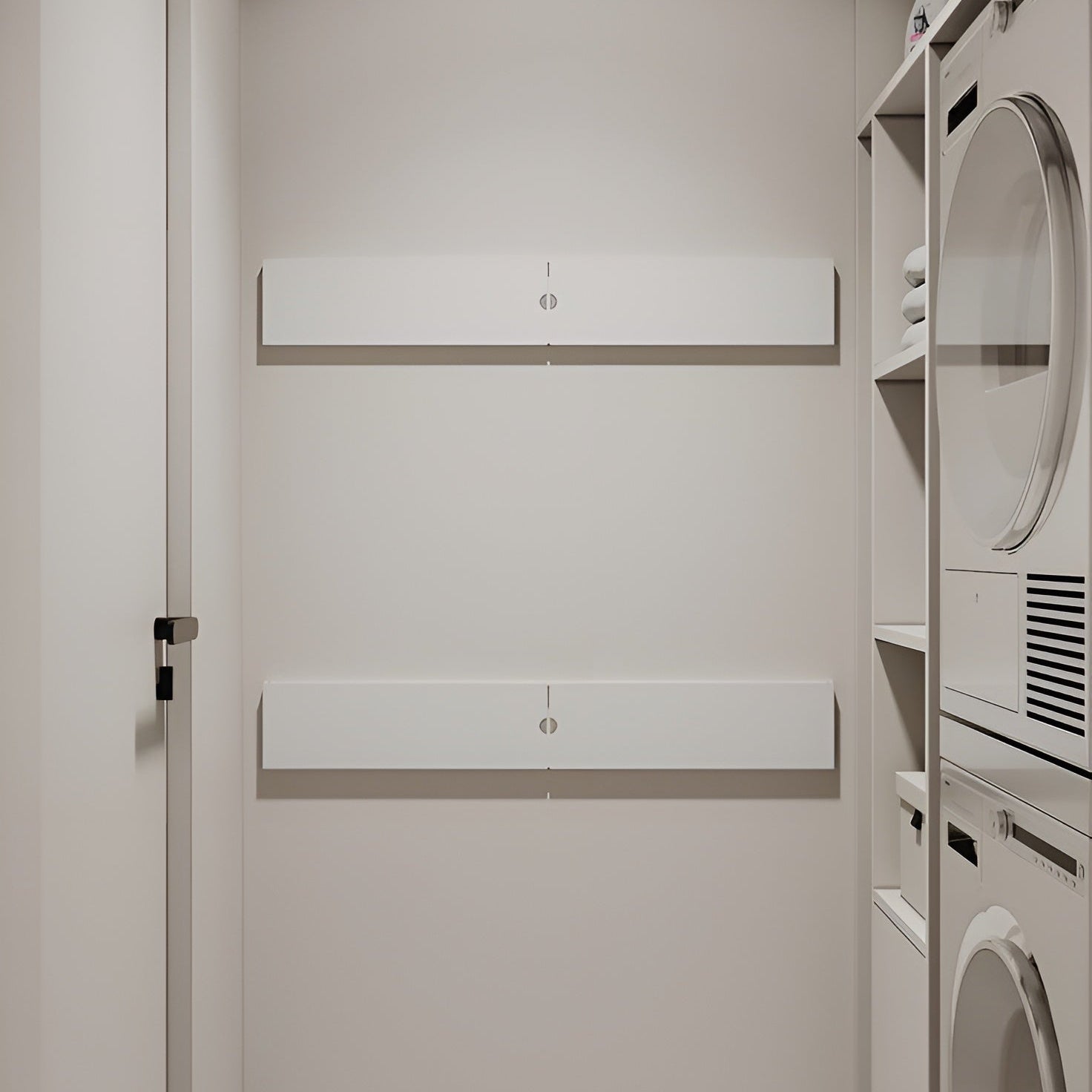 Modern laundry room with white cabinets and appliances.