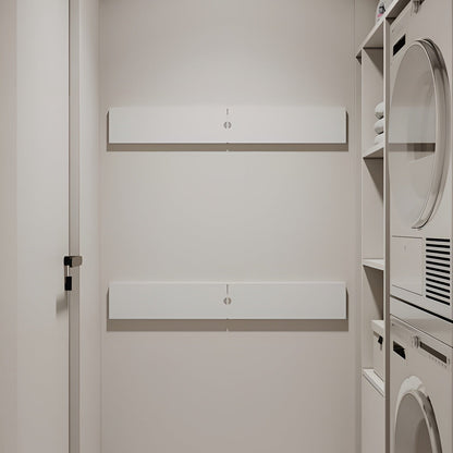 Modern laundry room with white cabinets and appliances.