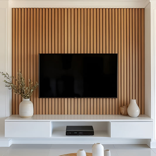 Modern living room with a television mounted on a wooden slat wall, white entertainment console, and decorative vases.