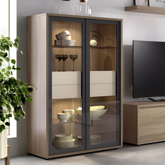 Wooden display cabinet with glass doors in a room setting with a TV and plant.