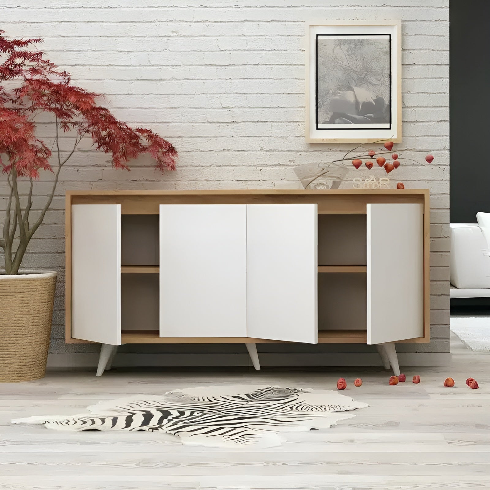 Modern wooden sideboard with white doors in a room with a plant and zebra rug.