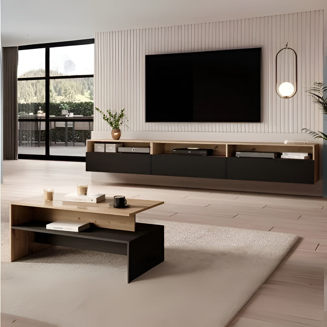 Modern living room with a TV mounted on the wall, a coffee table, and decorative items.