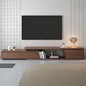 Wooden TV stand with a television mounted on a wall with a geometric tile pattern.
