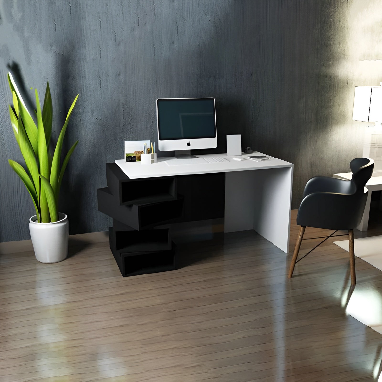 Modern office desk with computer setup in a room with a plant and chair.