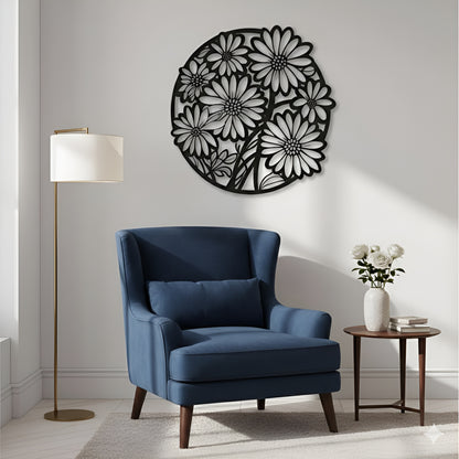 Blue armchair in a room with a decorative floral wall piece and a lamp.