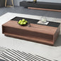 Modern coffee table with wooden finish and black top in a living room setting.