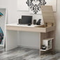 Wooden desk with computer setup against a white wall