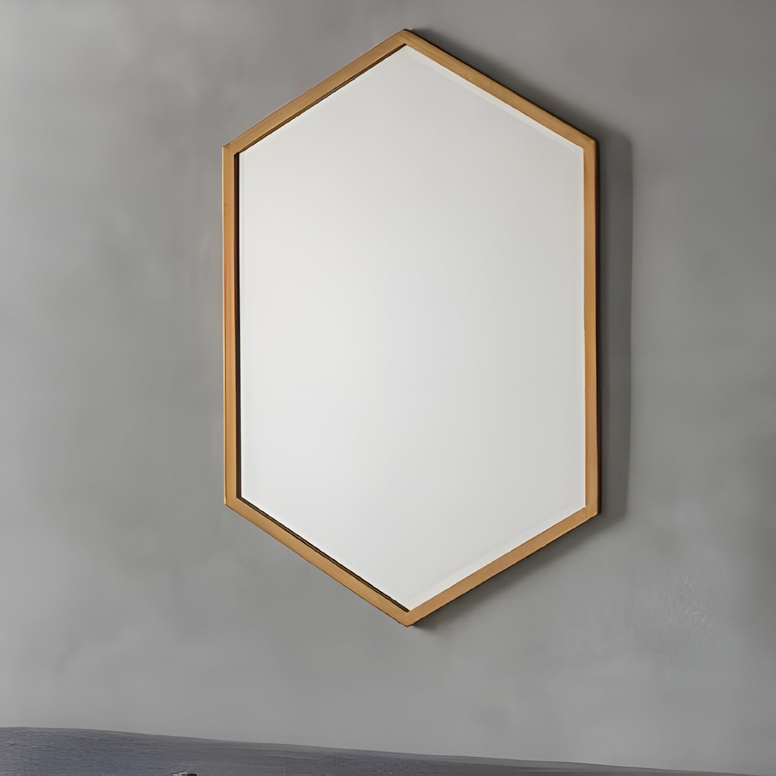 Hexagonal mirror with wooden frame on a gray wall