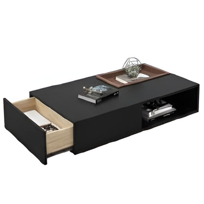 Black coffee table with open drawer and decorative items on a white background