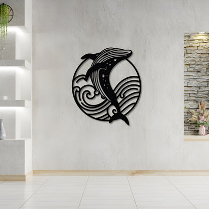 Decorative wall art of a dolphin and wave design on a white wall.