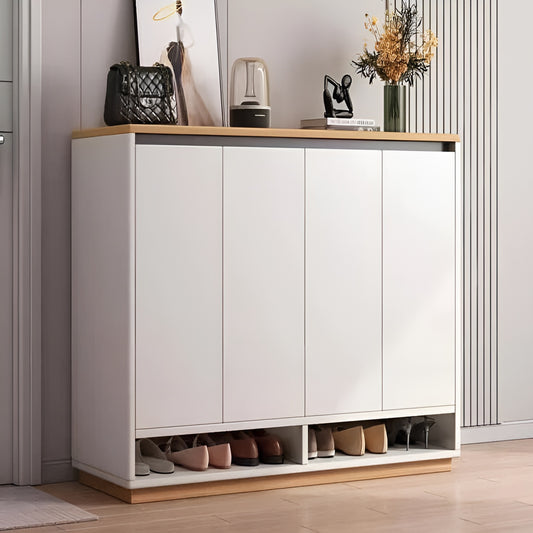White shoe cabinet with wooden accents in a room setting.