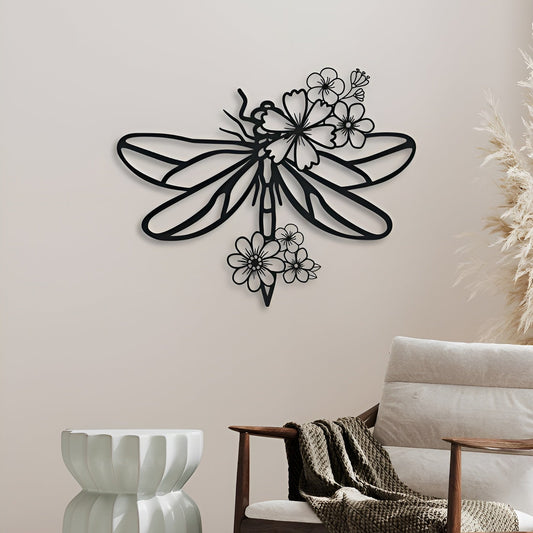 Decorative metal wall art of a dragonfly with floral elements on a wall.