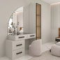 Modern white vanity with large mirror and chair in a minimalistic room.