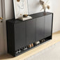 Black shoe cabinet with shoes inside, placed against a wall with decorative elements.