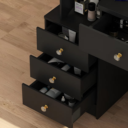 Black dresser with open drawers containing various items on a wooden floor.