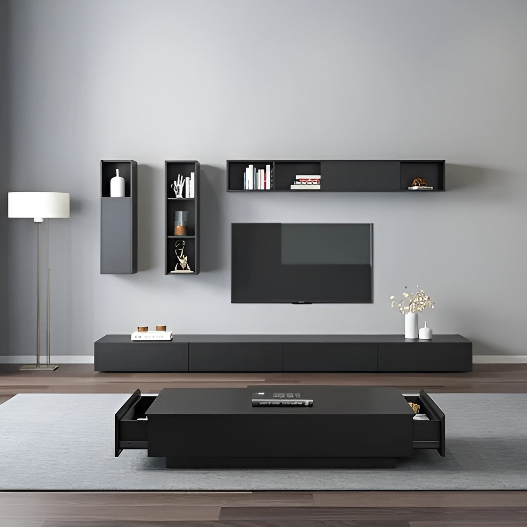 Modern living room with black entertainment unit, TV, and shelves against a gray wall.