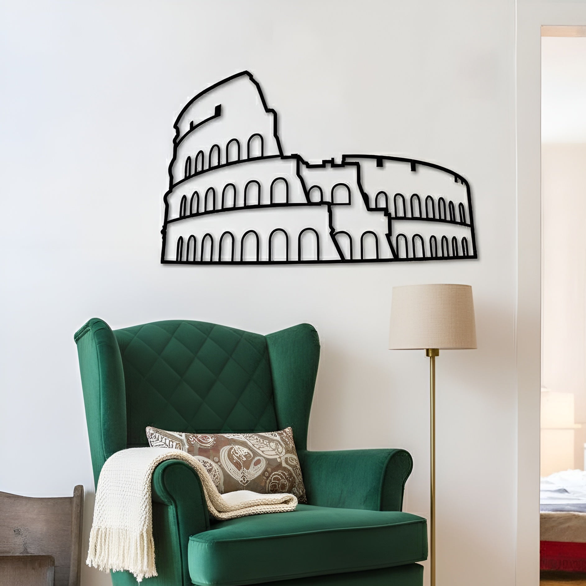 Green armchair with decorative pillow and blanket in a room with a Colosseum wall decal.