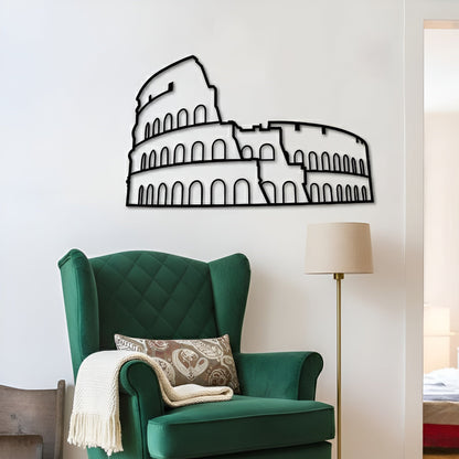 Green armchair with decorative pillow and blanket in a room with a Colosseum wall decal.