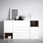White sideboard with decorative items against a gray wall