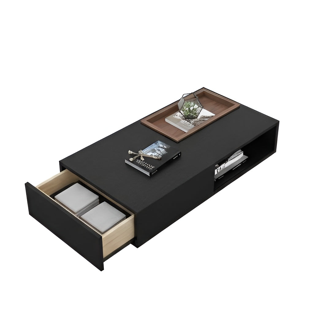 Black coffee table with open drawer and decorative items on a white background