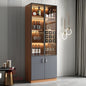 Modern bar cabinet with wine bottles and glasses in a stylish interior setting.