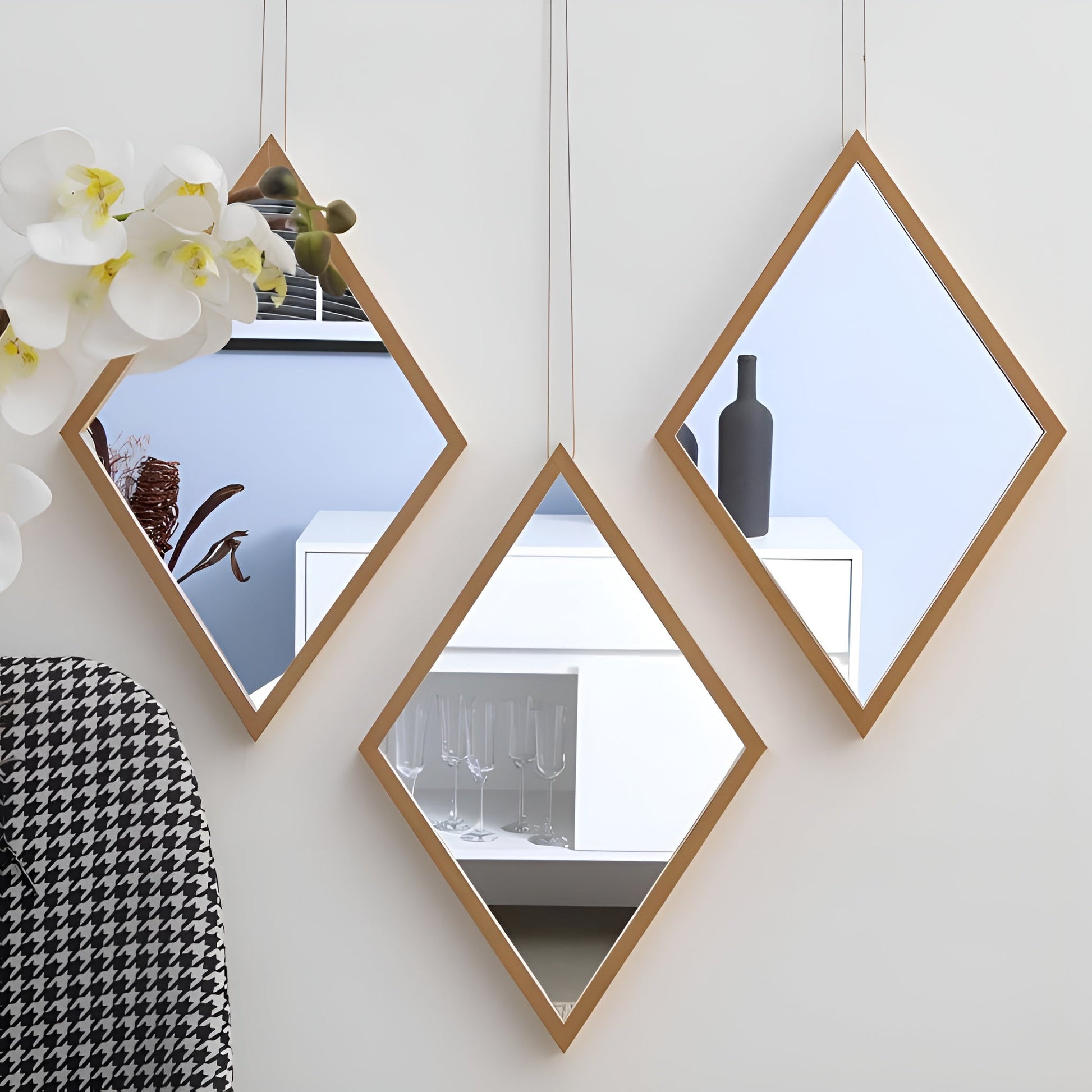 Hexagonal mirrors with wooden frames on a white wall, reflecting interior decor.