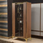 Wooden display cabinet with glass doors and gold accents against a neutral wall.
