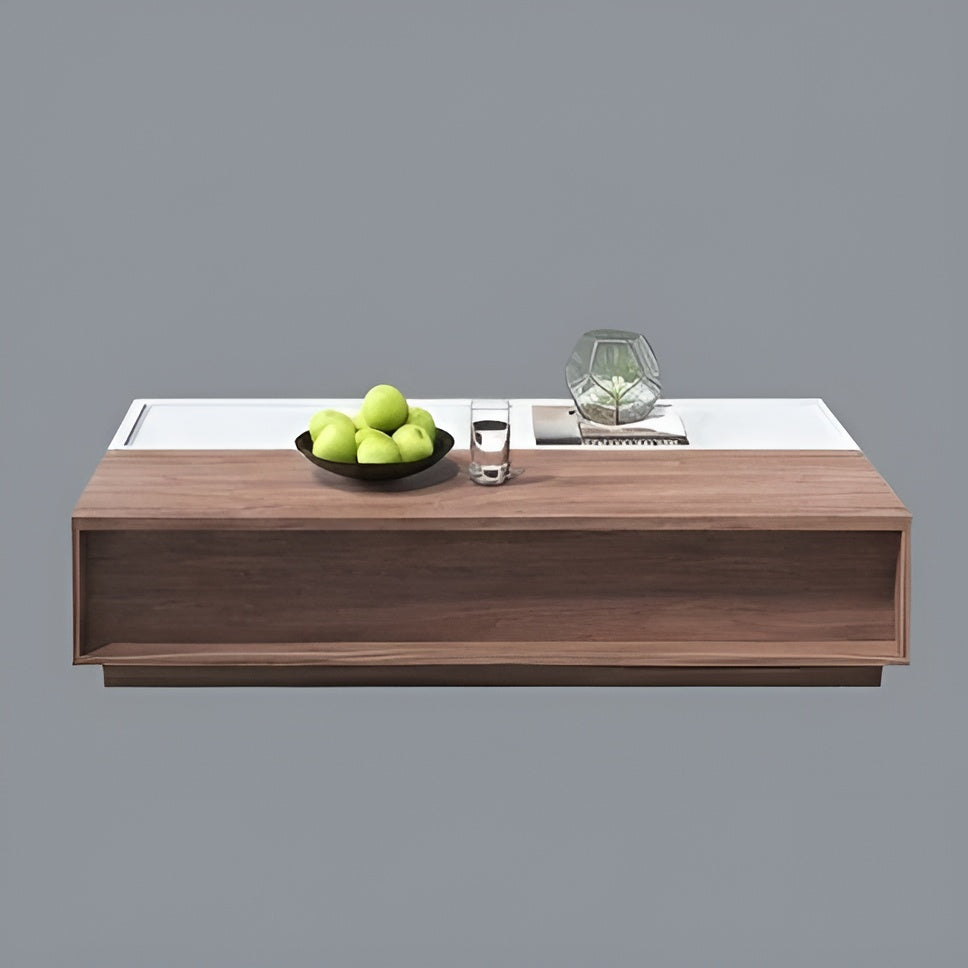Modern coffee table with a wooden finish and white top, featuring a bowl of apples and a glass.