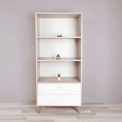 Wooden bookshelf with white drawer against a light gray wall
