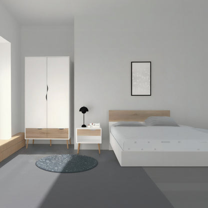 Modern bedroom with white wardrobe, nightstand, and bed against a gray wall.
