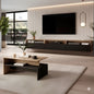 Modern living room with a TV mounted on a wall, a coffee table, and decorative elements.