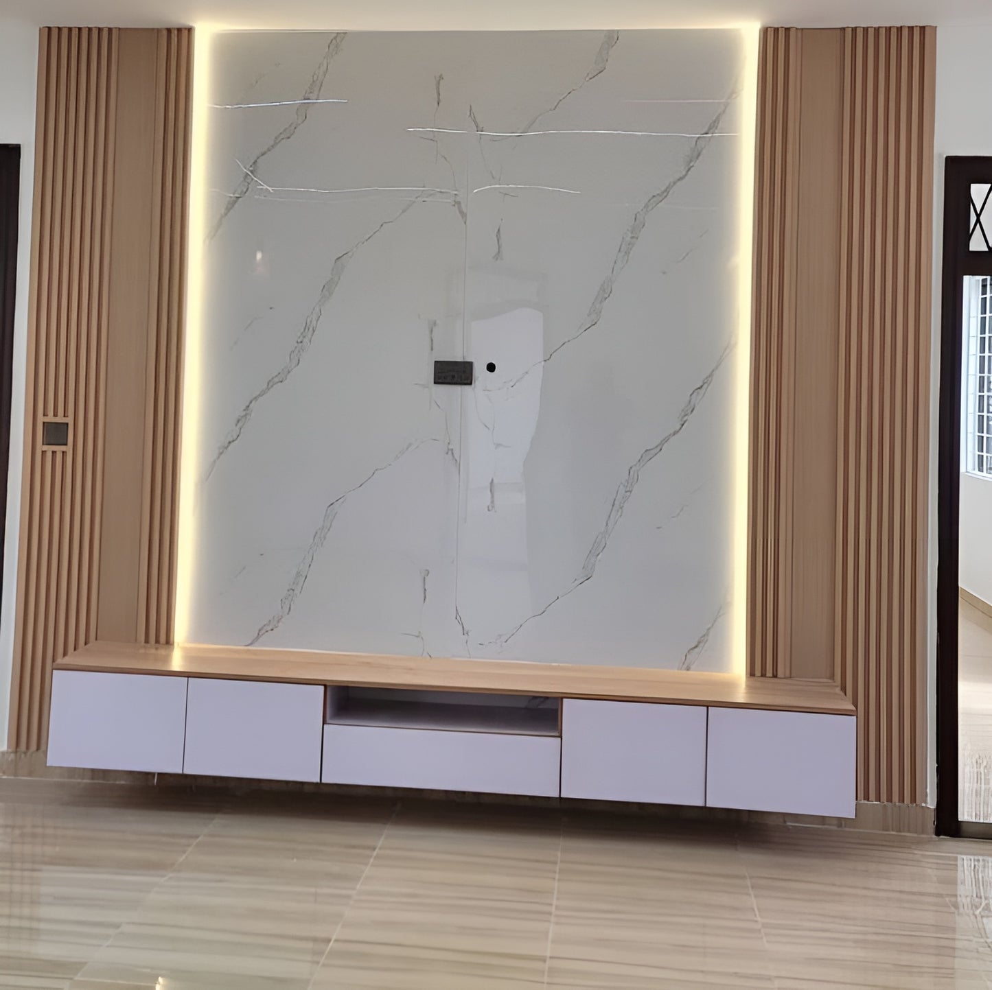 Modern living room with a large marble-patterned wall panel and wooden entertainment console.
