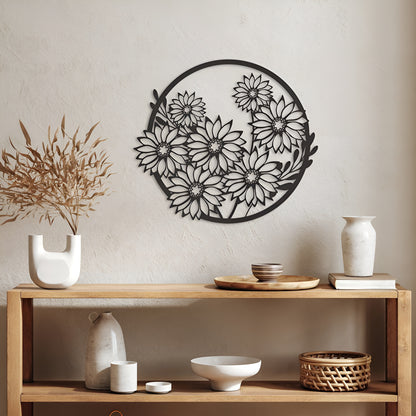 Decorative metal wall art with floral design on a neutral wall above a wooden shelf with decorative items.