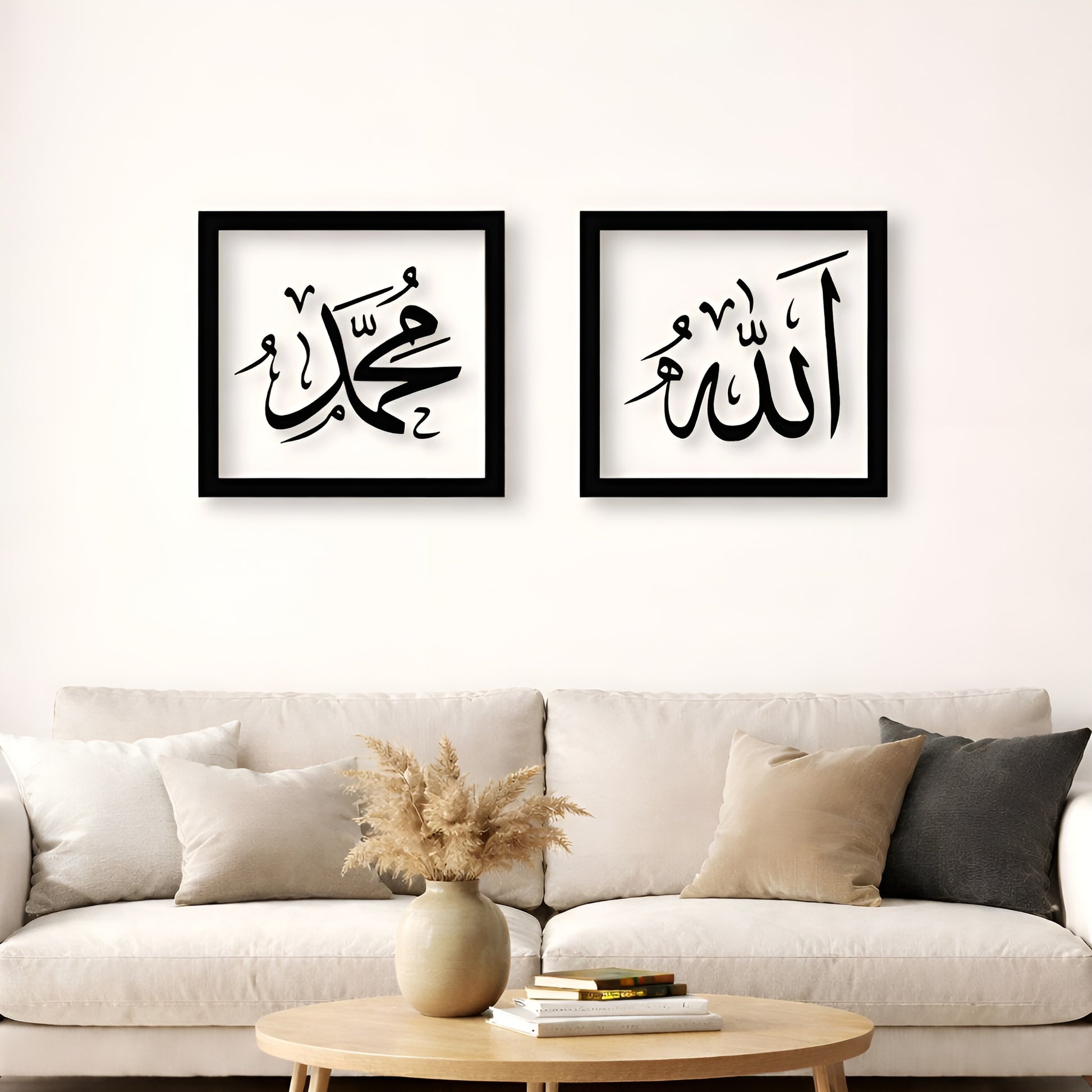 Two framed pieces of calligraphy art on a wall above a sofa.
