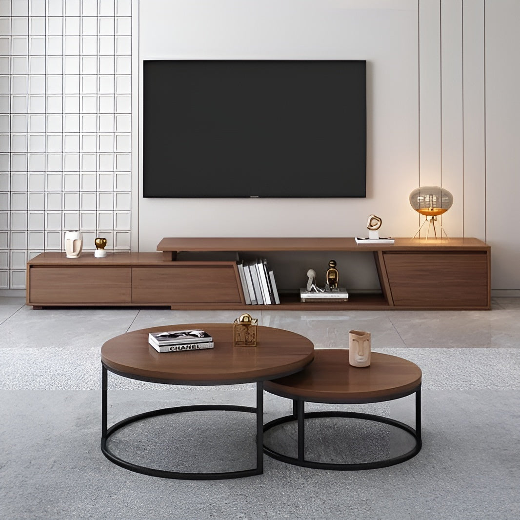 Modern living room with wooden TV stand, round coffee table, and decorative items.