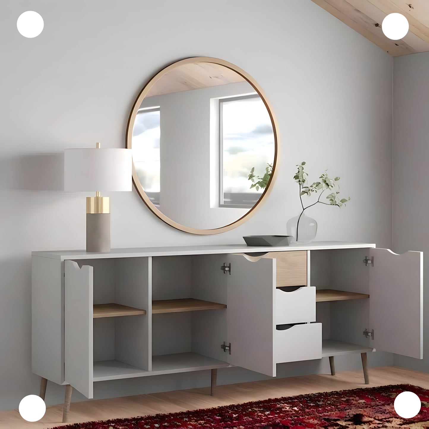 White cabinet with round mirror and decorative items in a room with wooden ceiling.