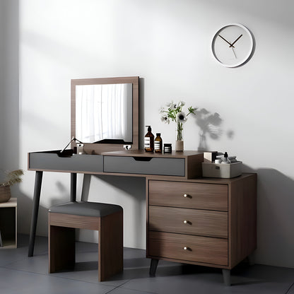 Dressing table with mirror, stool, and decorative items in a minimalistic room.