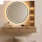 Round illuminated mirror with wooden vanity and shelves on a wall.