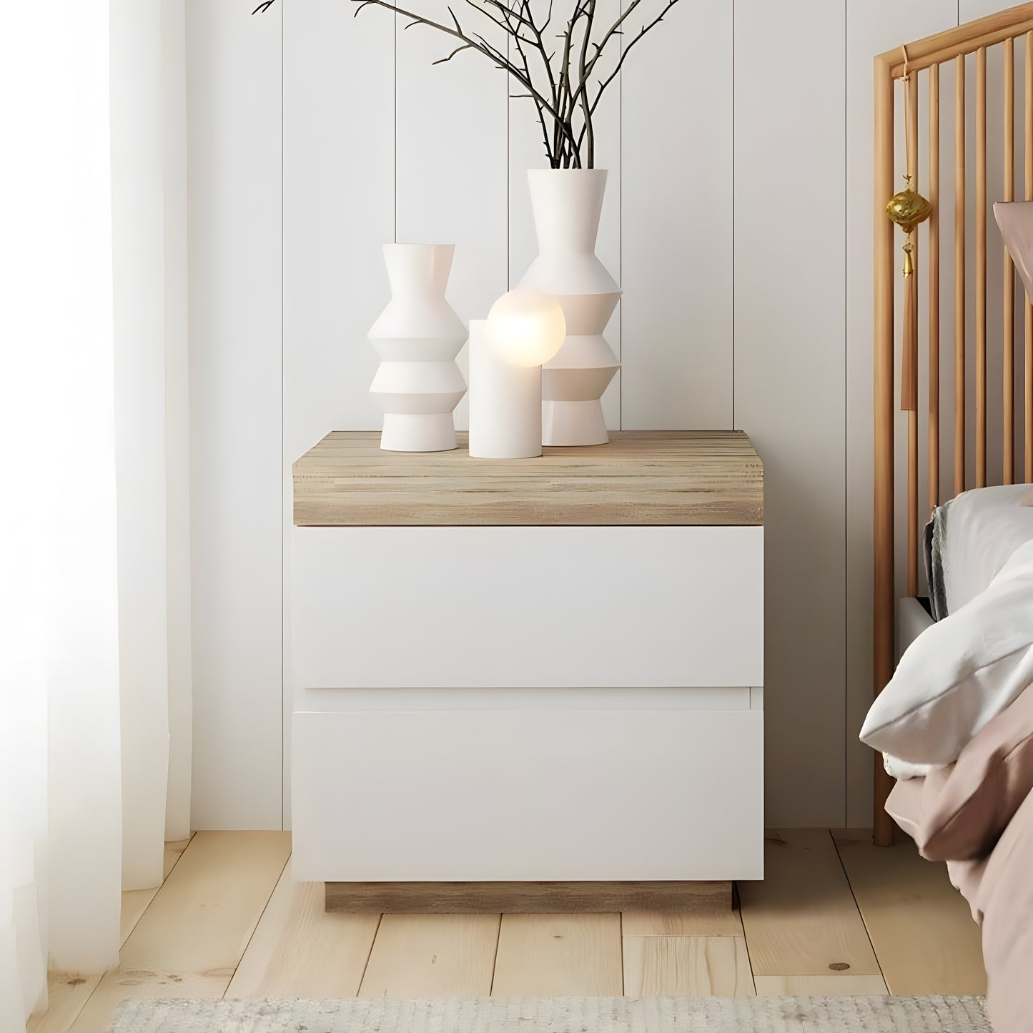 White nightstand with wooden top in a bedroom setting