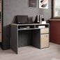 Modern office desk with a laptop and books in a room with a bookshelf and window.