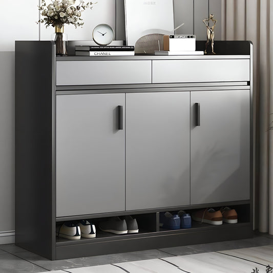 Modern shoe cabinet with open doors displaying shoes, placed against a neutral wall.