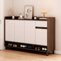 Wooden shoe cabinet with white doors and shoes inside, against a light wall.