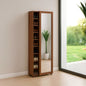 Tall wooden shoe cabinet with mirror next to a window with a view of greenery