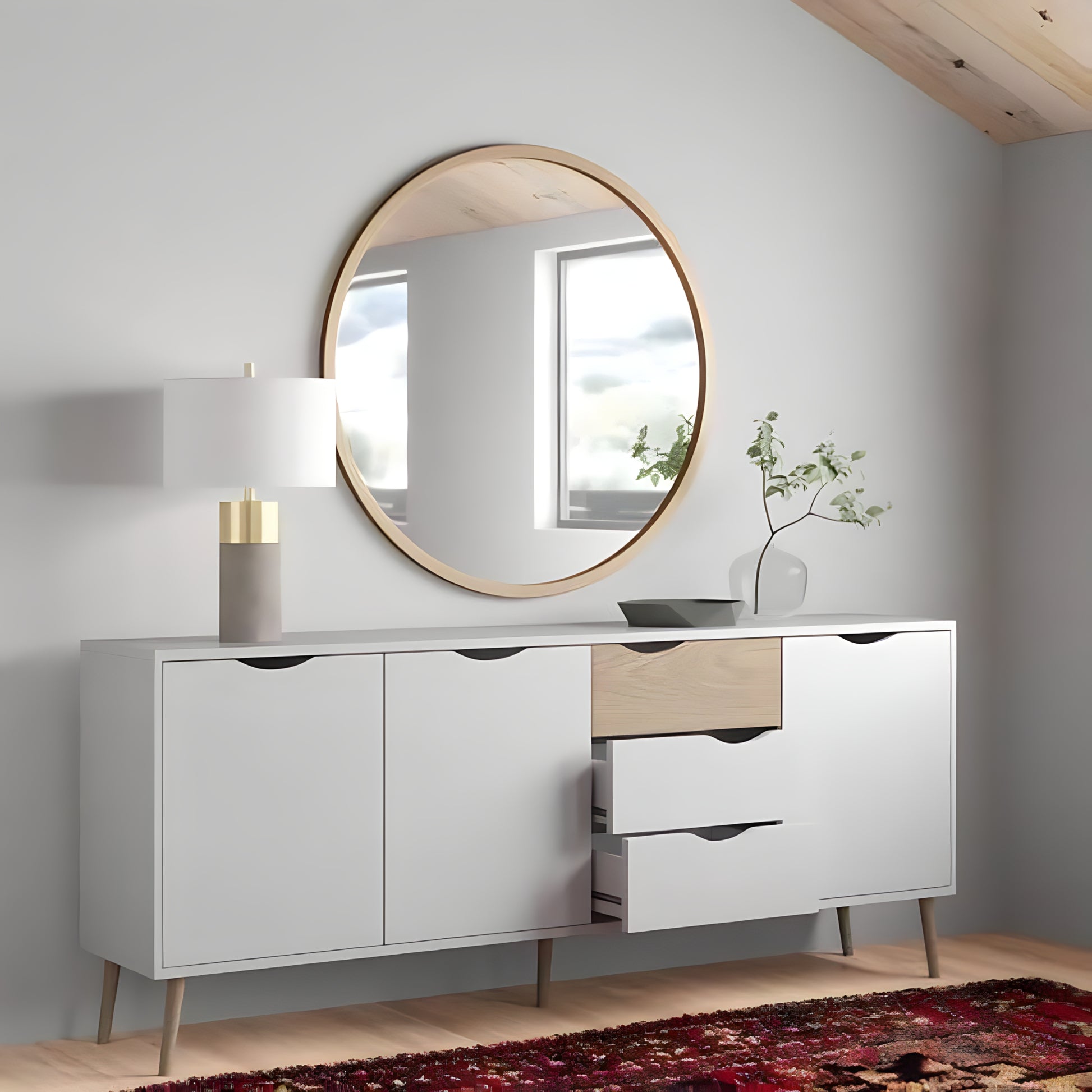 Modern sideboard with round mirror and decorative items in a room.